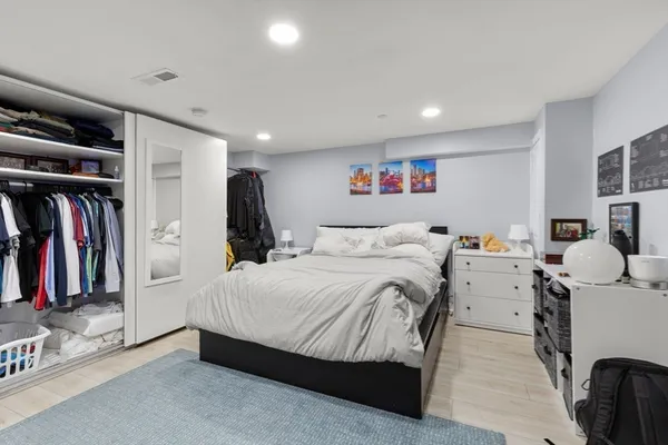 a bedroom with a bed and a walk in closet