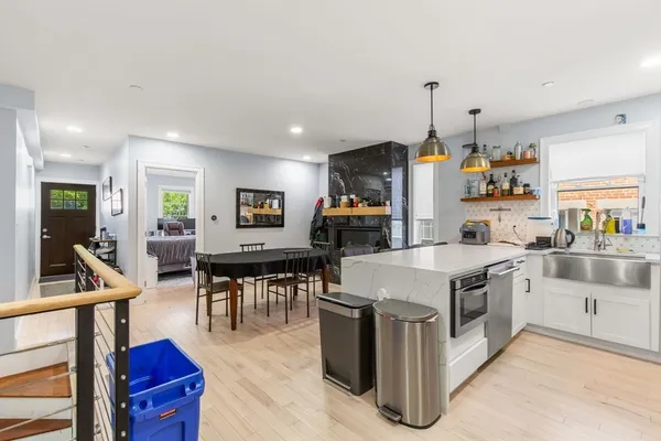 a kitchen with a stove a refrigerator and a dining table