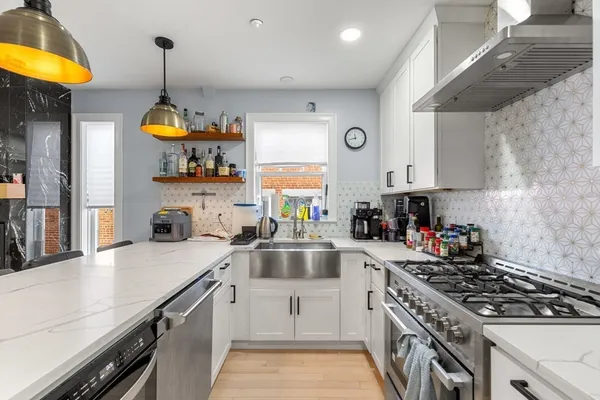 a kitchen with a sink appliances and cabinets
