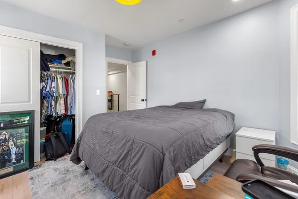 a bedroom with a bed and a mirror