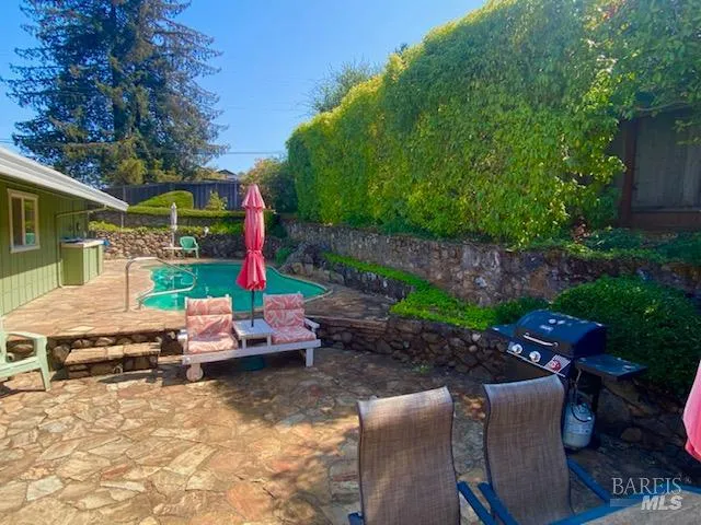 a bedroom with a bed and a dresser with mirror