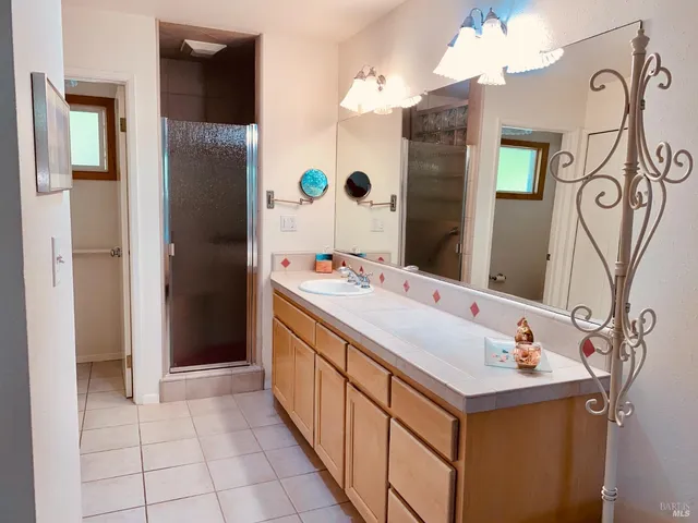 a bathroom with a double vanity sink and mirror