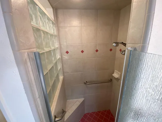 a bathroom with a toilet and a shower
