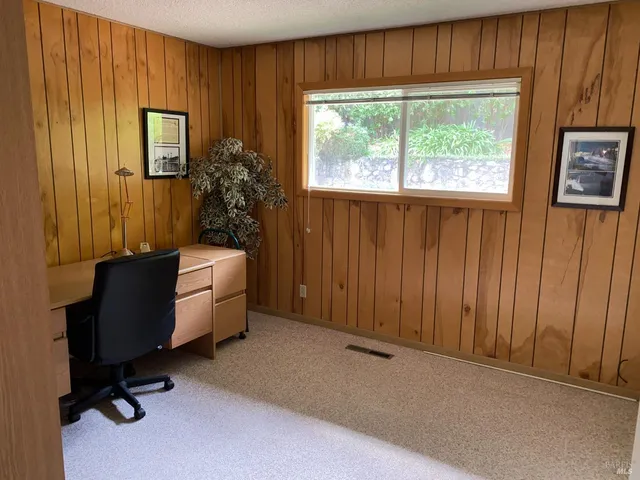 a view of a balcony with wooden floor and fence