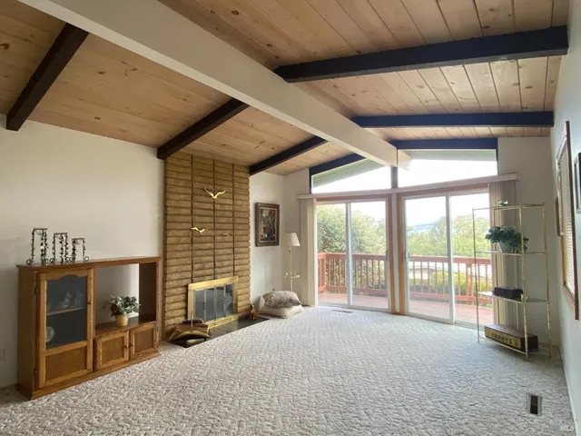 a living room with a large bed and a large window