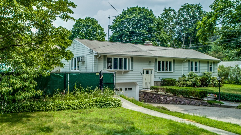 a front view of a house with a yard table and chairs