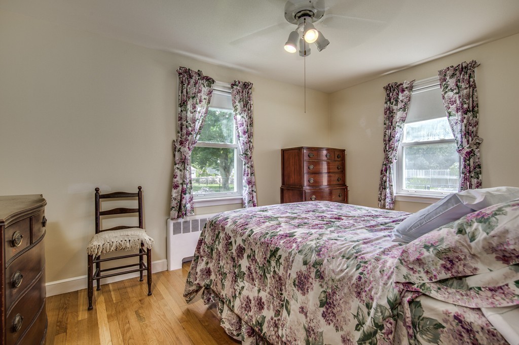 21 Putnam Road Bedford, MA 01730 - Photo 12 of 21 a bedroom with a bed and wooden floor