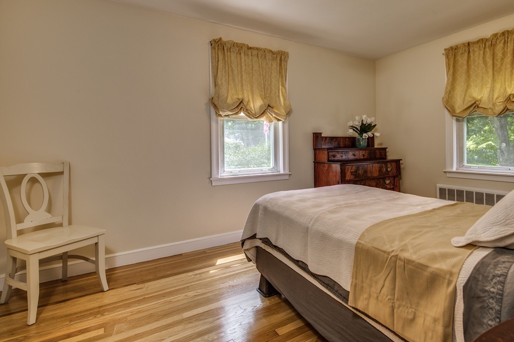 21 Putnam Road Bedford, MA 01730 - Photo 13 of 21 a bed sitting in a bedroom next to a window