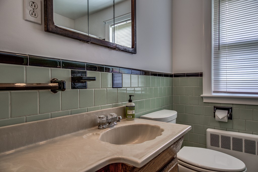 21 Putnam Road Bedford, MA 01730 - Photo 15 of 21 a bathroom with a sink toilet and mirror