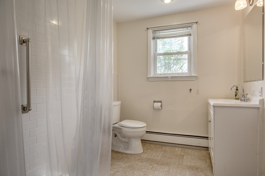 21 Putnam Road Bedford, MA 01730 - Photo 16 of 21 a bathroom with a toilet sink and a mirror