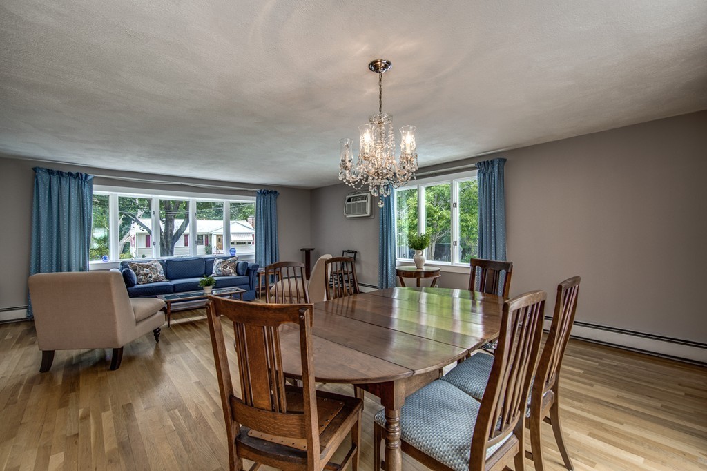 21 Putnam Road Bedford, MA 01730 - Photo 5 of 21 a dining room with furniture a chandelier and wooden floor