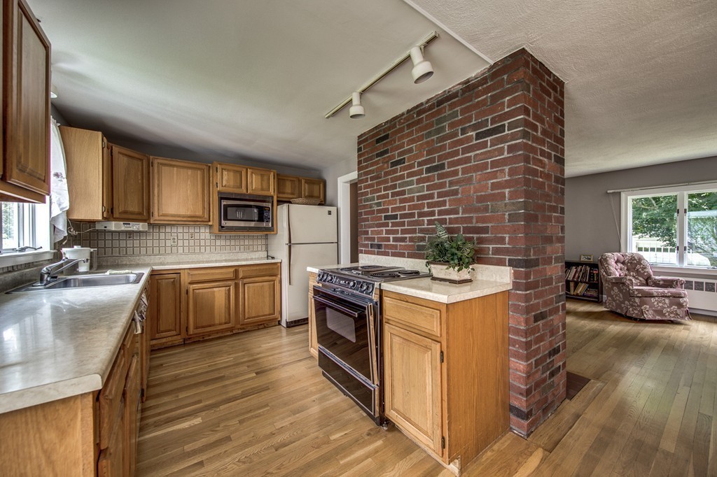 21 Putnam Road Bedford, MA 01730 - Photo 9 of 21 a kitchen with a stove sink and cabinets