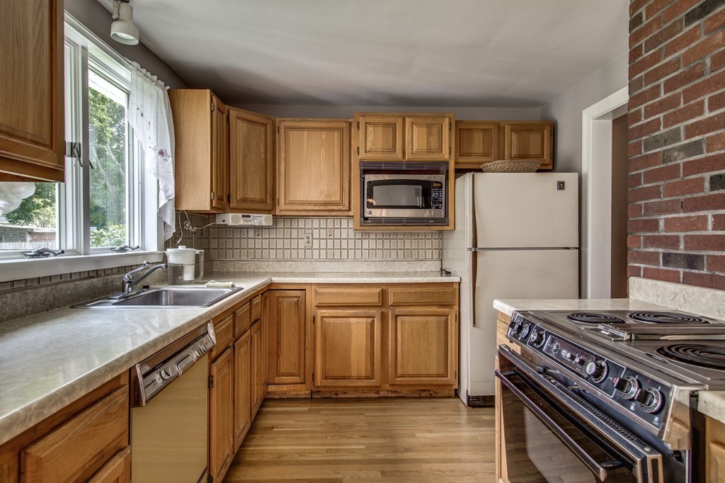 21 Putnam Road Bedford, MA 01730 - Photo 10 of 21 a kitchen with a stove a sink and a refrigerator
