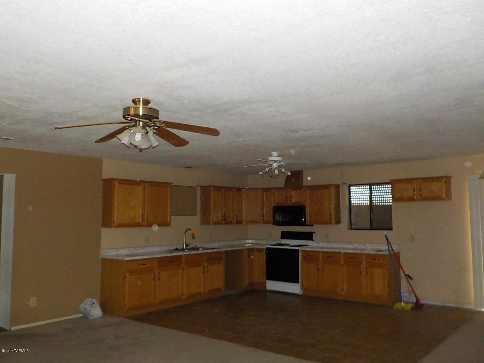 338 Taylor Road Willcox, AZ 85643 - Photo 4 of 21 a large kitchen with stainless steel appliances kitchen island granite countertop a sink and cabinets
