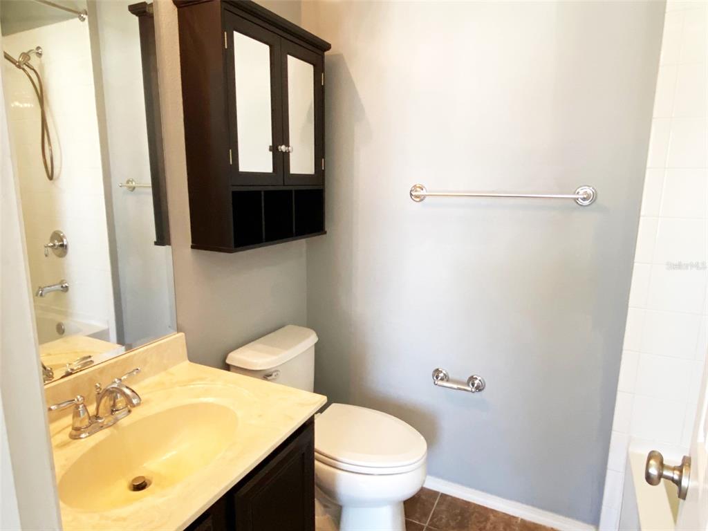 8946 White Sage Loop Lakewood Ranch, FL 34202 - Photo 30 of 36 a bathroom with a toilet a sink and a mirror