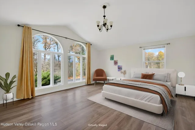 a bedroom with a bed and a large window