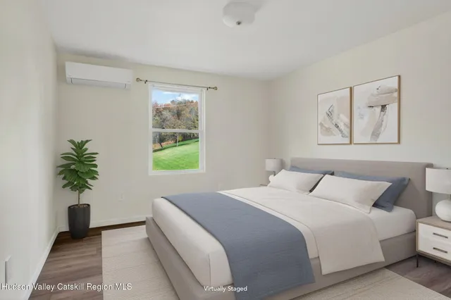 a bedroom with a bed and a potted plant