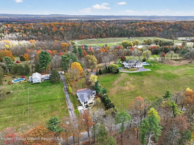 an aerial view of a house with a garden and lake view
