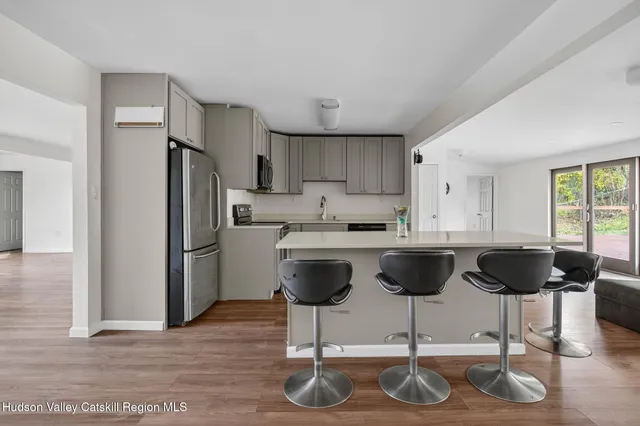 a kitchen with stainless steel appliances granite countertop a refrigerator and a stove top oven