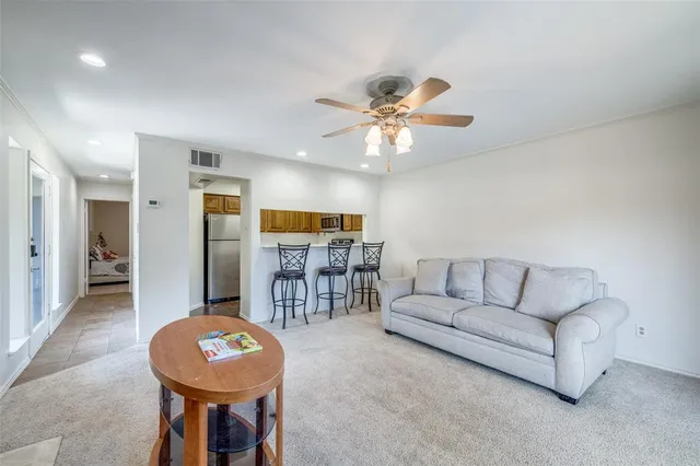 a living room with furniture and kitchen view