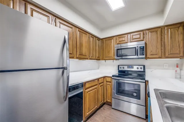 a kitchen with a refrigerator sink and stove top oven