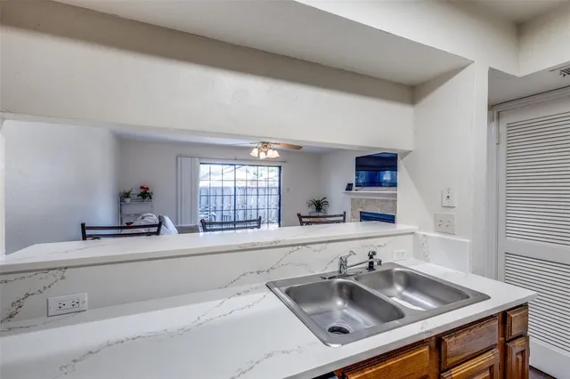 a kitchen with sink and a window