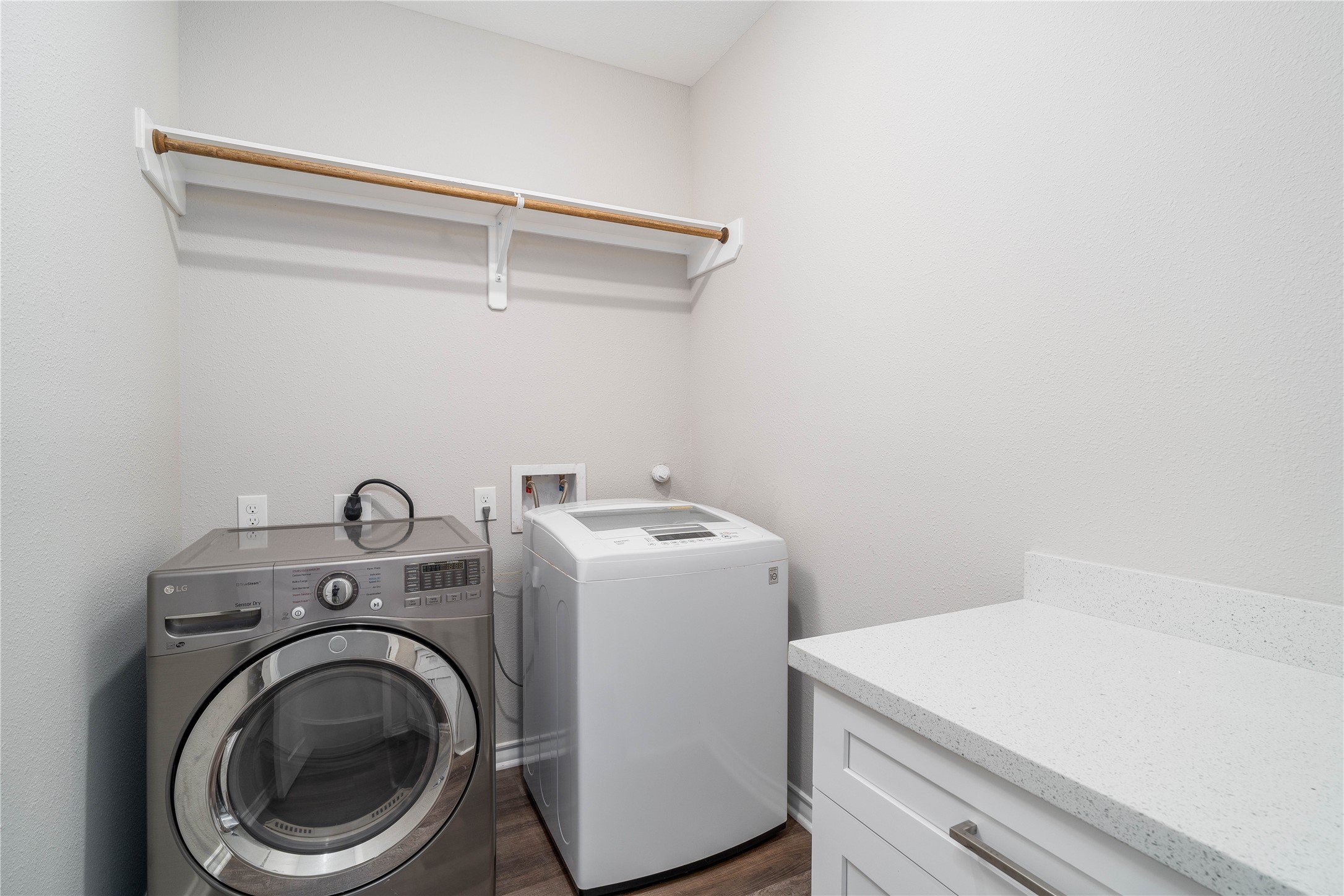 231 McCormick Street Columbus, TX 78934 - Photo 22 of 27 Laundry Room – Dedicated laundry space with washer and dryer connections, overhead shelving, and additional counter space for folding and organization.