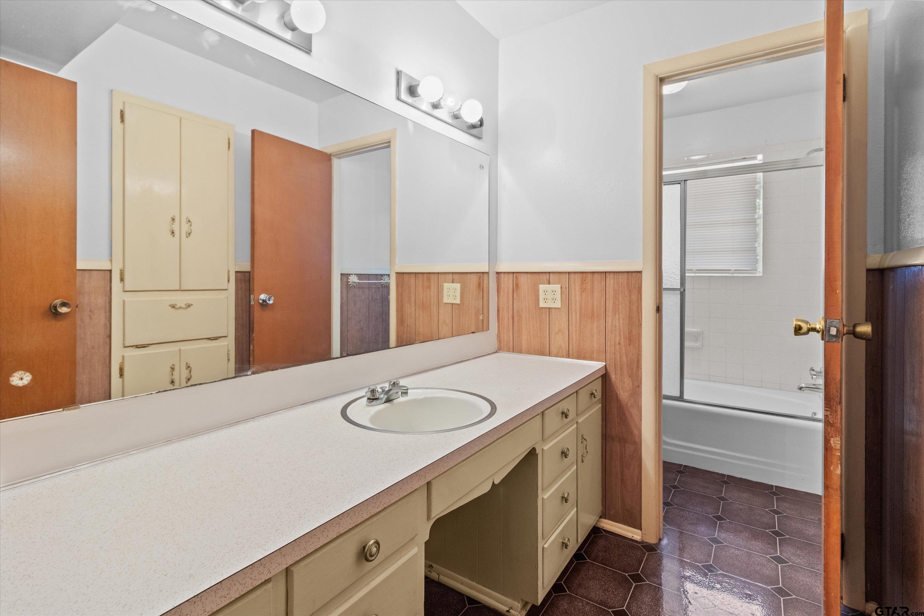 4168 Gallion Avenue Tyler, TX 75708 - Photo 14 of 27 a bathroom with a sink and a mirror