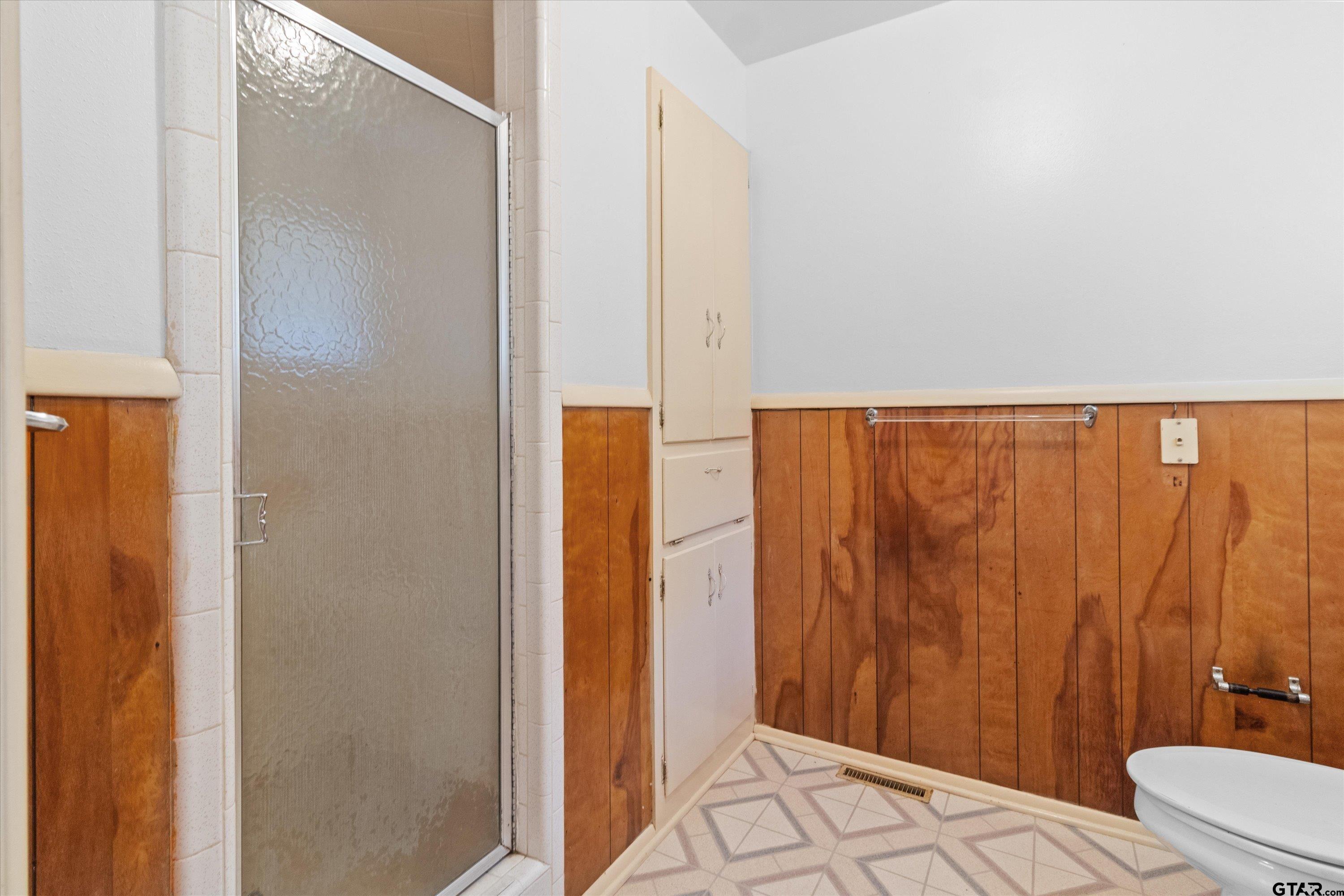 4168 Gallion Avenue Tyler, TX 75708 - Photo 17 of 27 a bathroom with a shower and a toilet