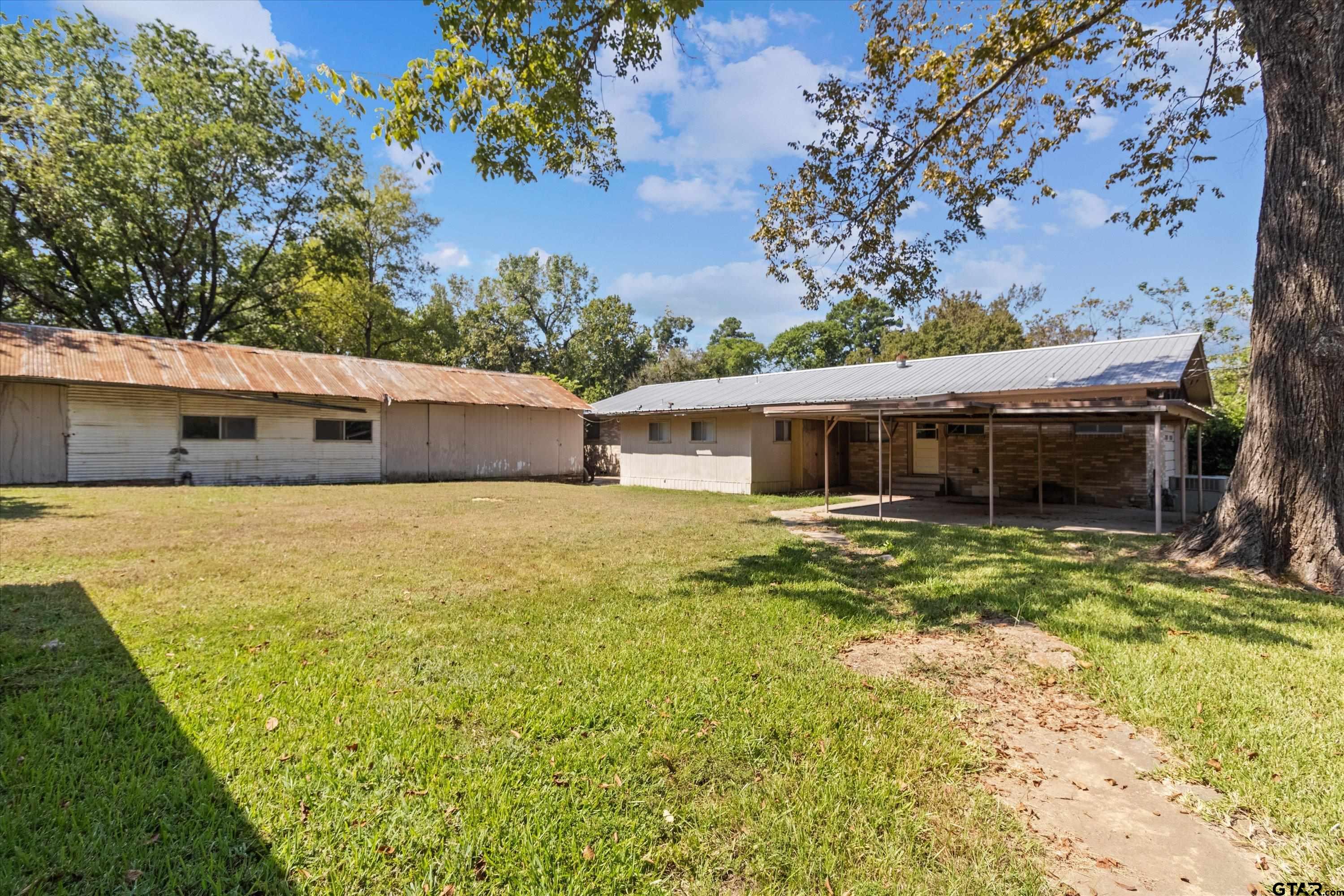 4168 Gallion Avenue Tyler, TX 75708 - Photo 24 of 27 a front view of a house with a garden