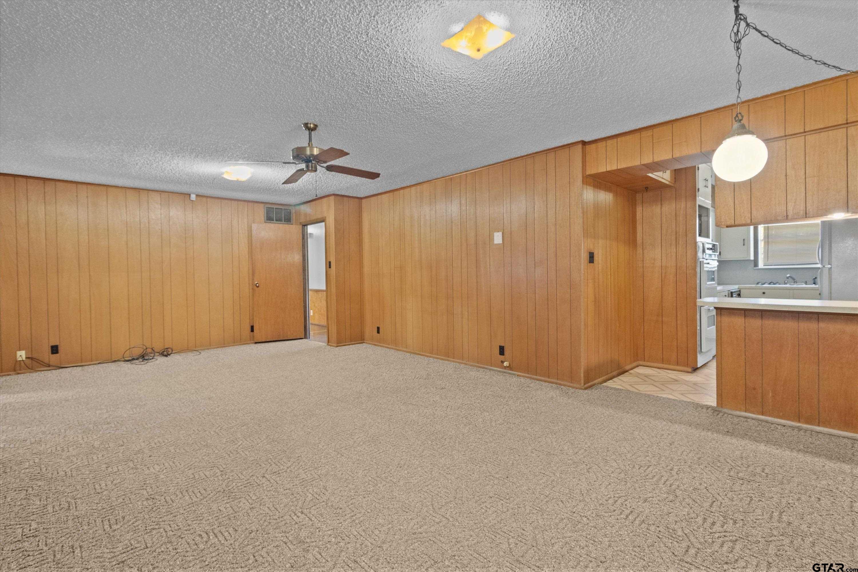 4168 Gallion Avenue Tyler, TX 75708 - Photo 4 of 27 a view of an empty room with window and cabinet