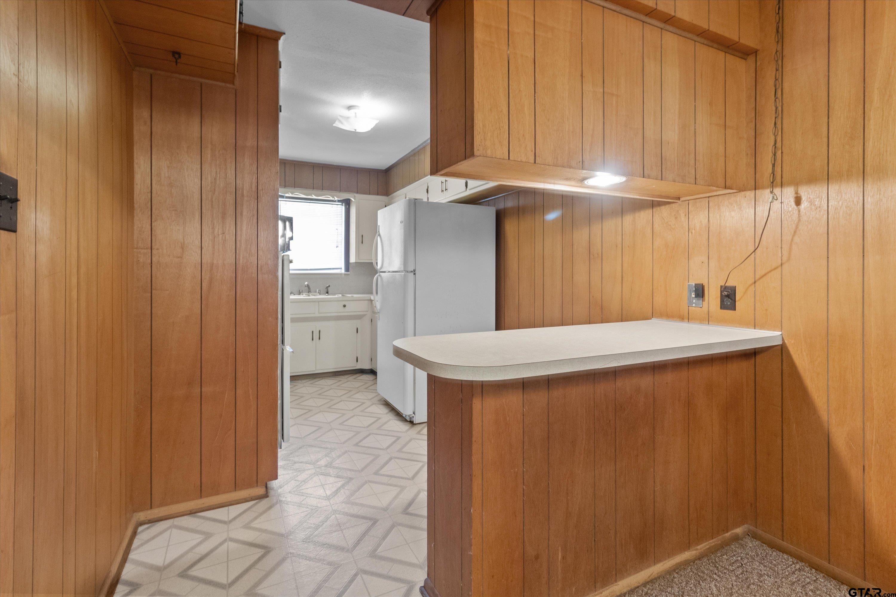 4168 Gallion Avenue Tyler, TX 75708 - Photo 7 of 27 a kitchen with stainless steel appliances a refrigerator and a sink
