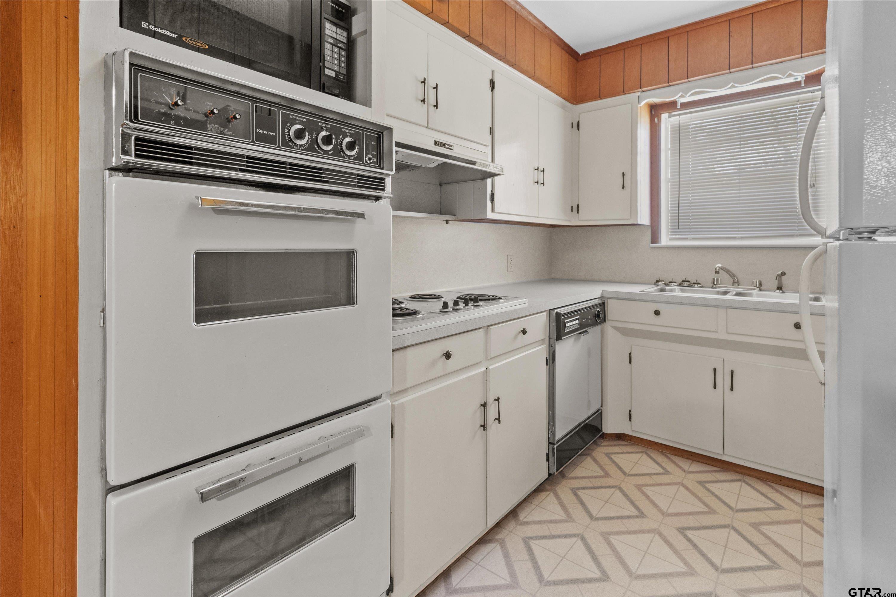 4168 Gallion Avenue Tyler, TX 75708 - Photo 8 of 27 a kitchen with white cabinets appliances and sink
