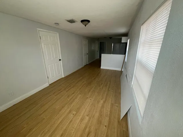 a view of a room with wooden floor and stairs