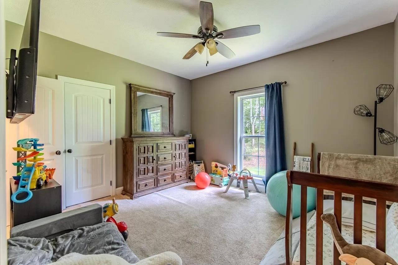 2134 Otis Plunk Road Bethel Springs, TN 38315 - Photo 19 of 35 a bedroom with a bed and a chandelier