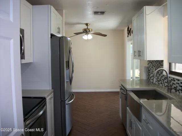a kitchen with a sink appliances and cabinets