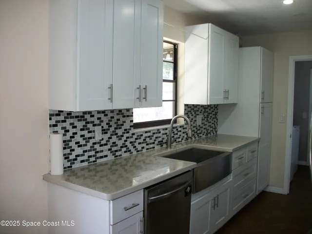 a kitchen with a sink and cabinets