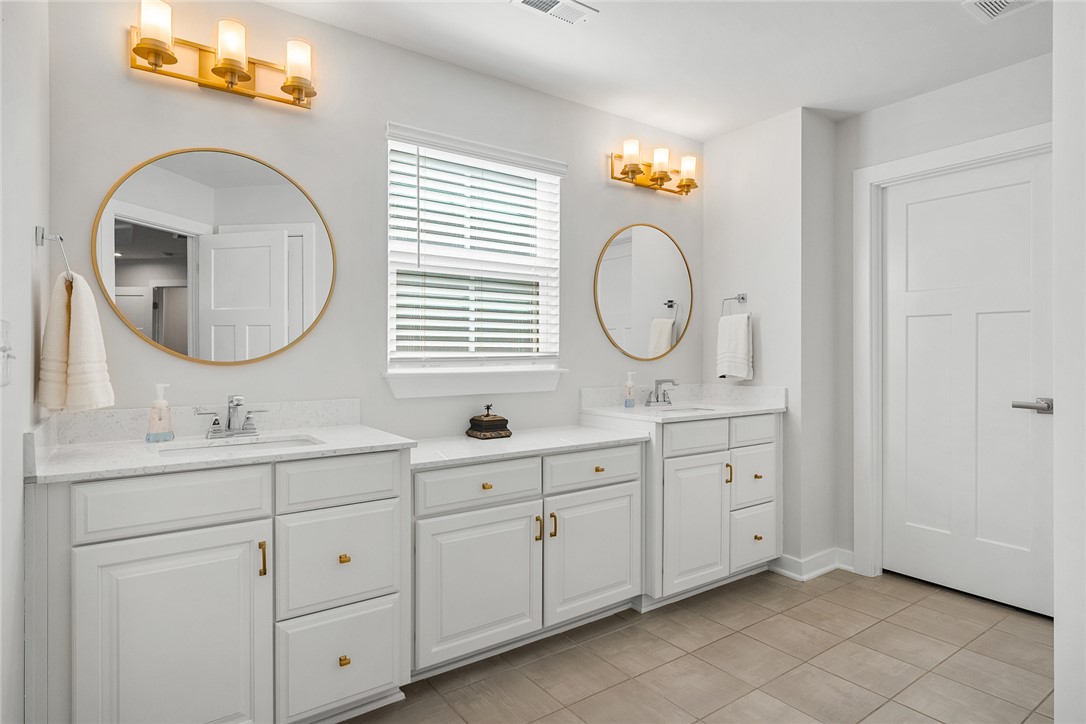 115 Bronson Ridge Anderson, SC 29621 - Photo 25 of 40 Dual vanities topped with stone counters anchor this bright and clean master bathroom space.