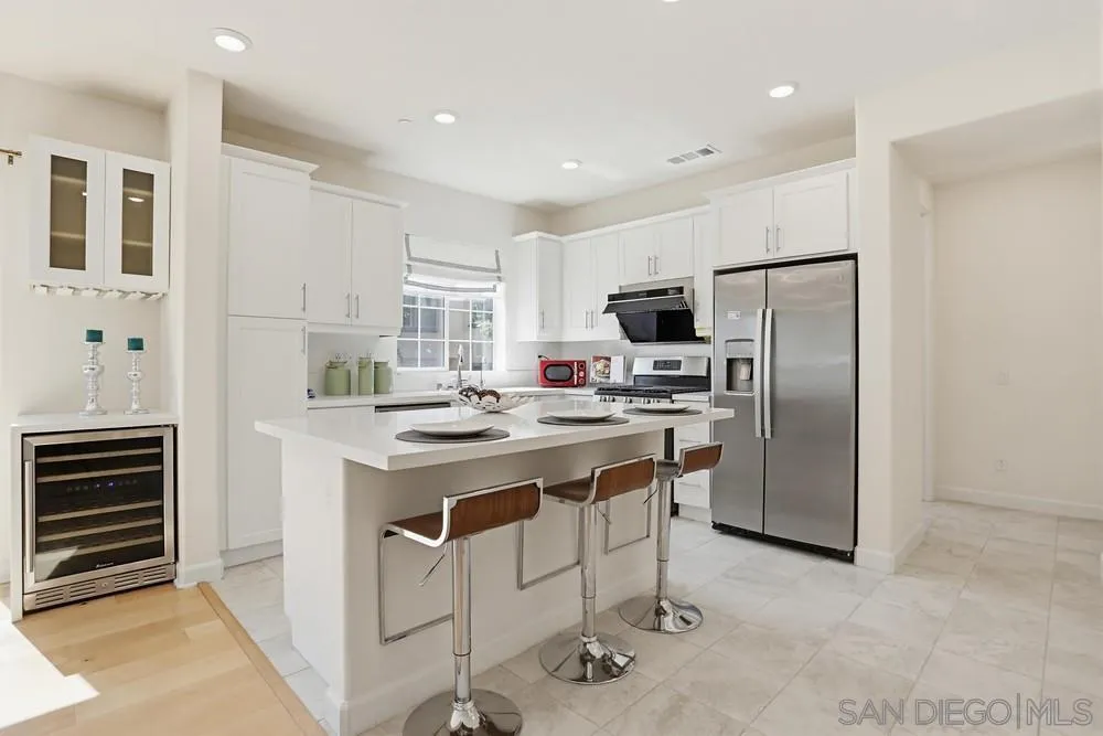4373 Pacifica Way, Unit 6 Oceanside, CA 92056 - Photo 13 of 48 a kitchen with stainless steel appliances a stove a sink and a refrigerator