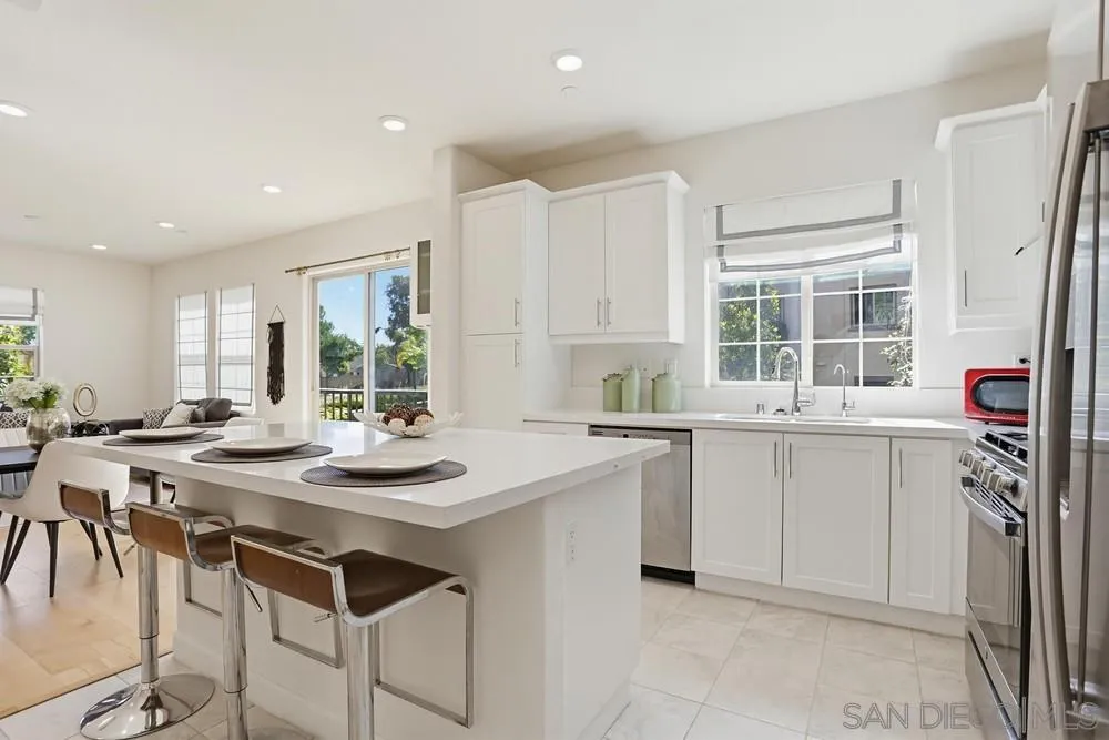 4373 Pacifica Way, Unit 6 Oceanside, CA 92056 - Photo 14 of 48 a kitchen with a sink stove and cabinets
