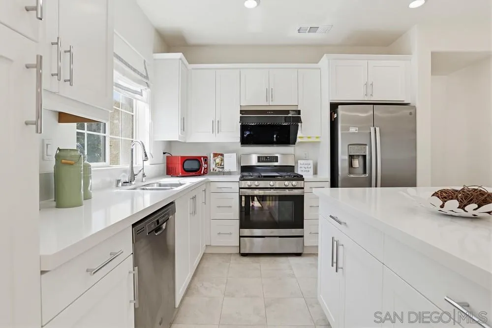 4373 Pacifica Way, Unit 6 Oceanside, CA 92056 - Photo 15 of 48 a kitchen with a sink white stove and refrigerator