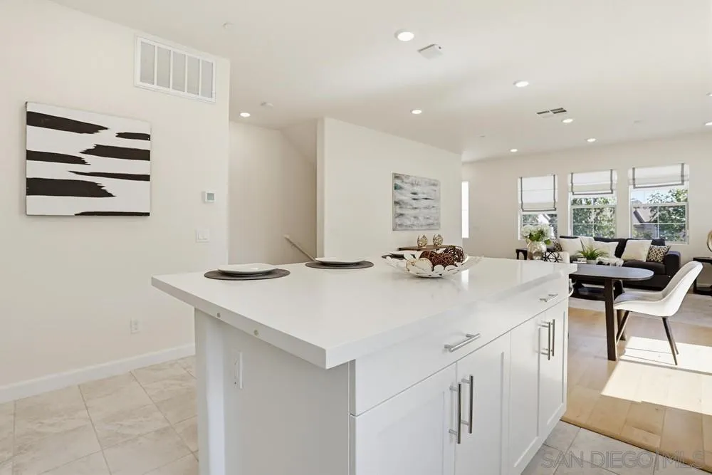 4373 Pacifica Way, Unit 6 Oceanside, CA 92056 - Photo 16 of 48 a kitchen with a sink a stove and chairs