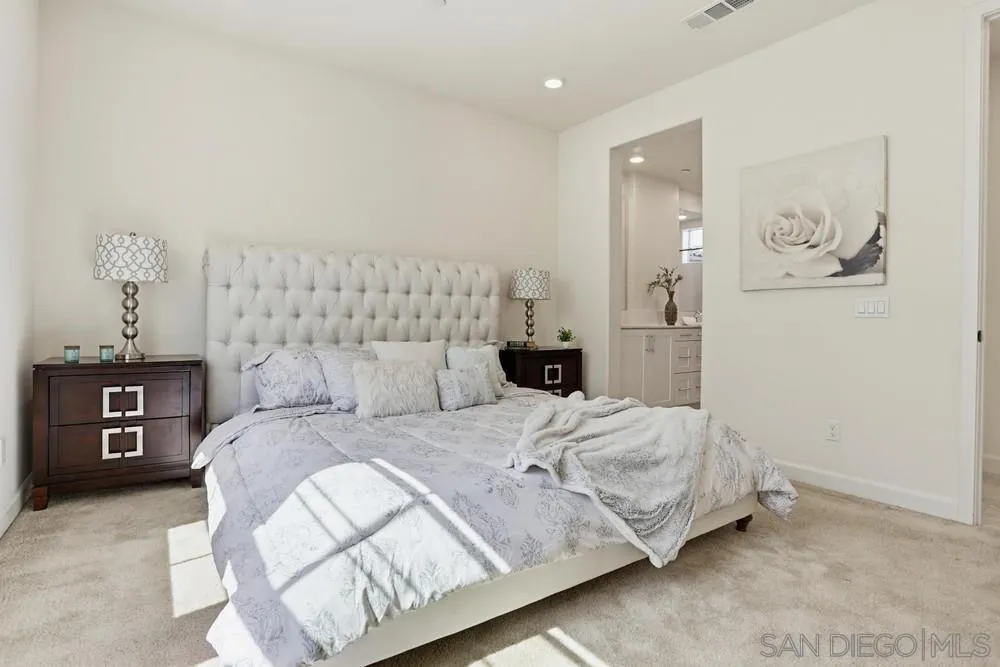 4373 Pacifica Way, Unit 6 Oceanside, CA 92056 - Photo 21 of 48 a bedroom with a bed and a lamp