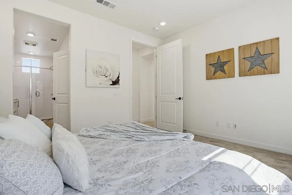 4373 Pacifica Way, Unit 6 Oceanside, CA 92056 - Photo 22 of 48 a bedroom with a bed and a painting on the wall