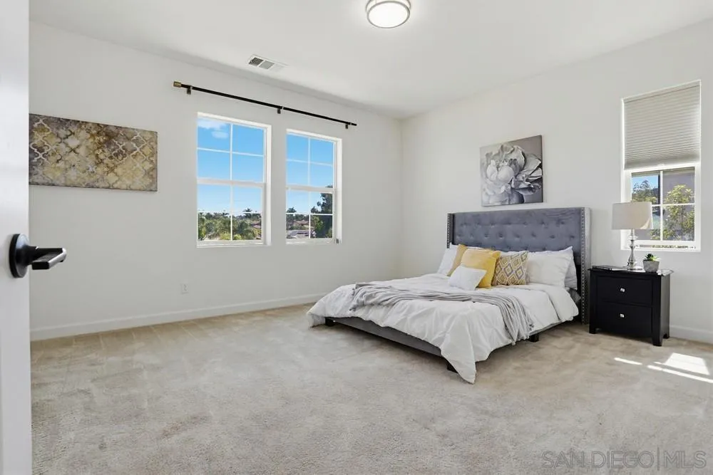 4373 Pacifica Way, Unit 6 Oceanside, CA 92056 - Photo 27 of 48 a spacious bedroom with a bed and a window
