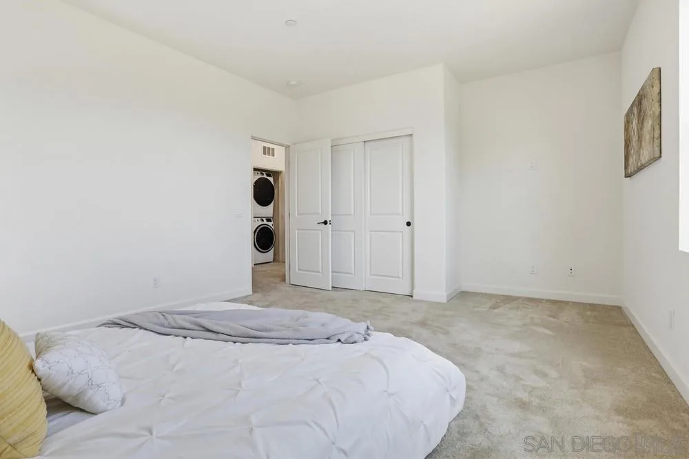 4373 Pacifica Way, Unit 6 Oceanside, CA 92056 - Photo 28 of 48 a bedroom with a bed and cabinets
