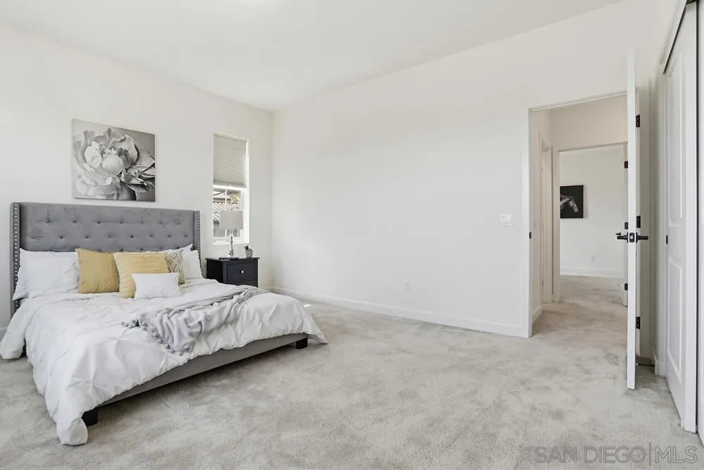 4373 Pacifica Way, Unit 6 Oceanside, CA 92056 - Photo 29 of 48 a bedroom with a bed and a painting on the wall