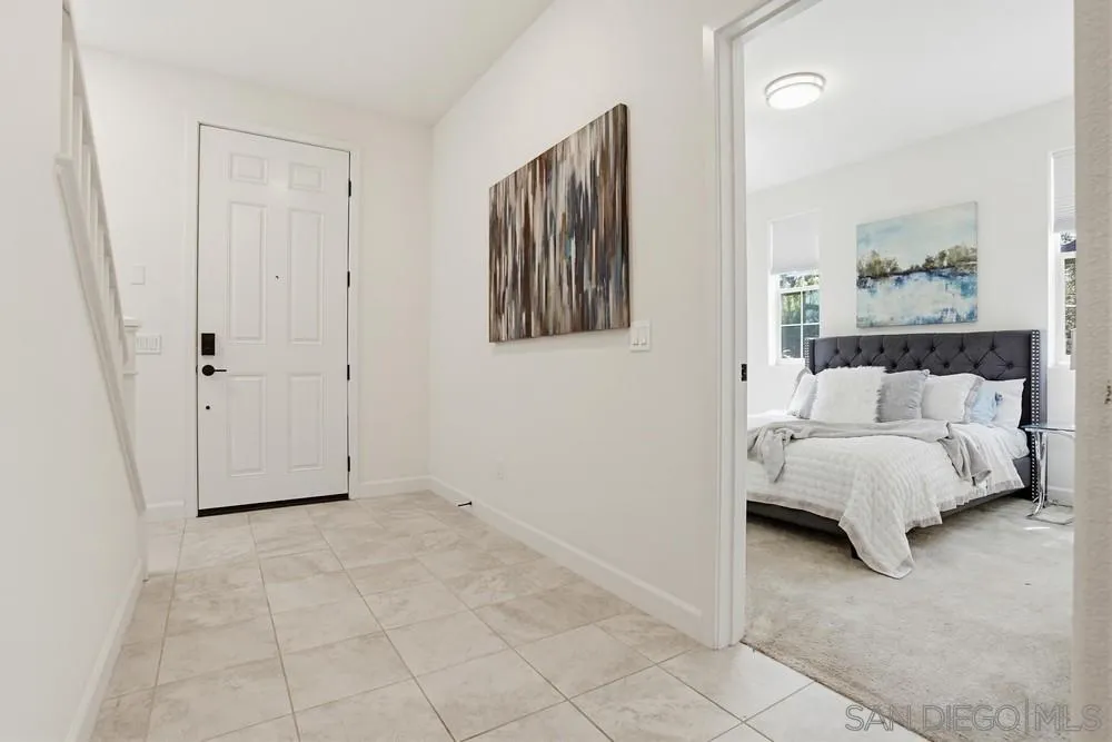 4373 Pacifica Way, Unit 6 Oceanside, CA 92056 - Photo 35 of 48 a view of a bedroom with a bed and wall painting