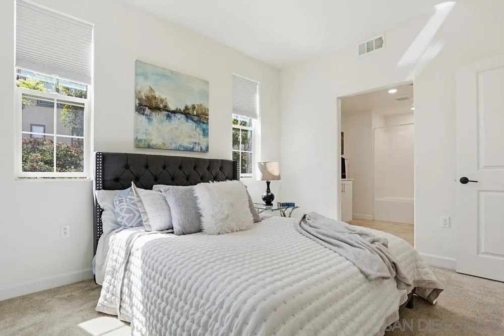 4373 Pacifica Way, Unit 6 Oceanside, CA 92056 - Photo 37 of 48 a bedroom with bed and wooden floor