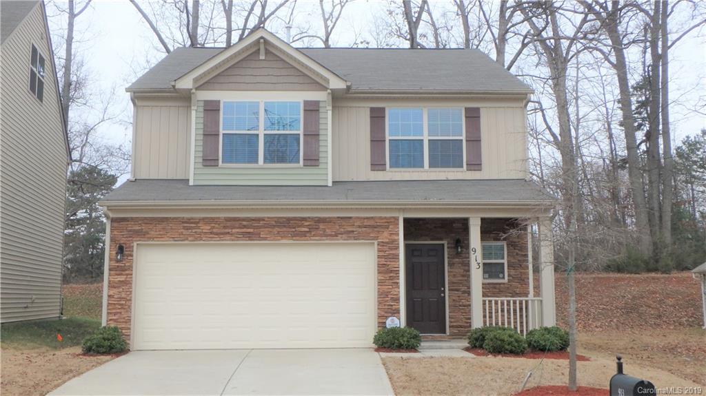 913 Rook Road Charlotte, NC 28216 - Photo 1 of 22 a front view of a house with garage and yard